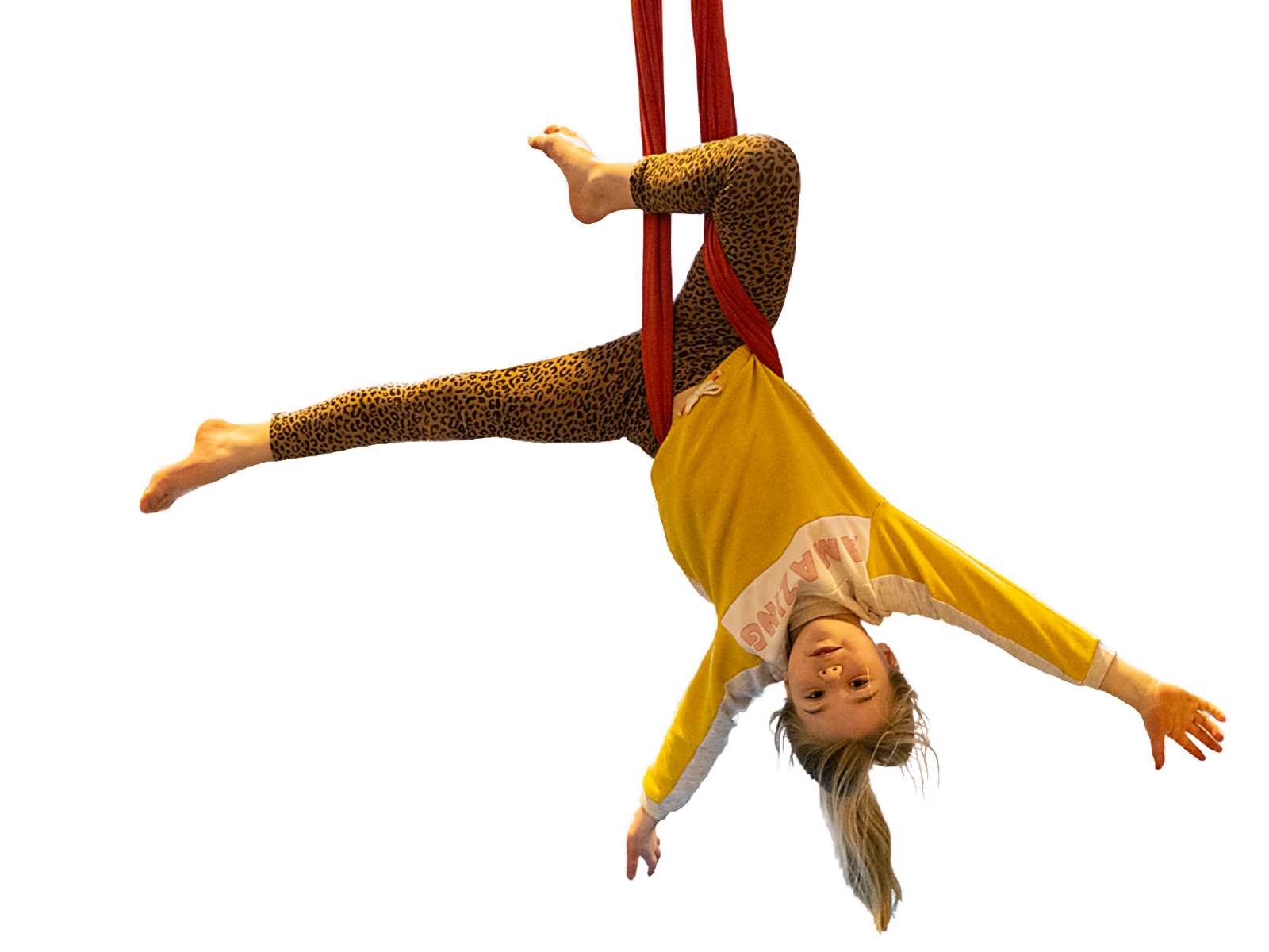 Girl hanging upside down supported by a strap
