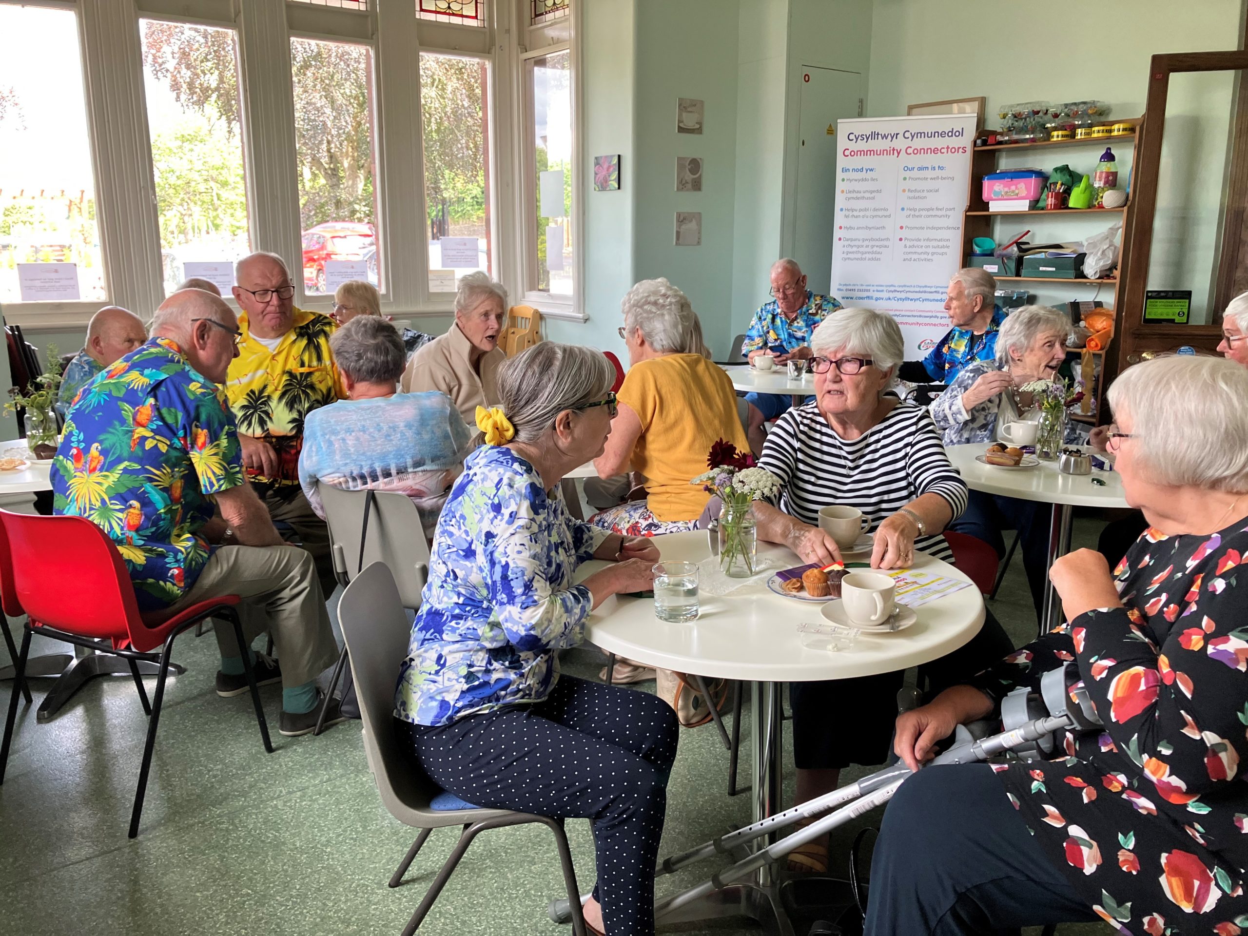 Elderly people chatting with cups of tea