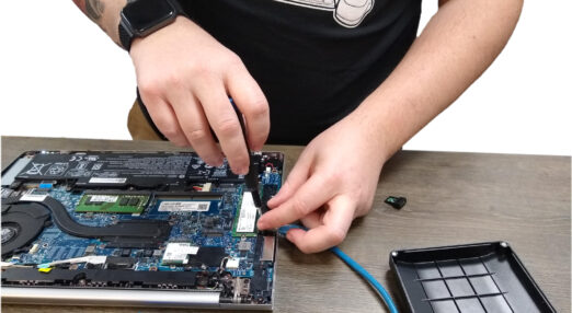 Man's hands mending a computer motherboard