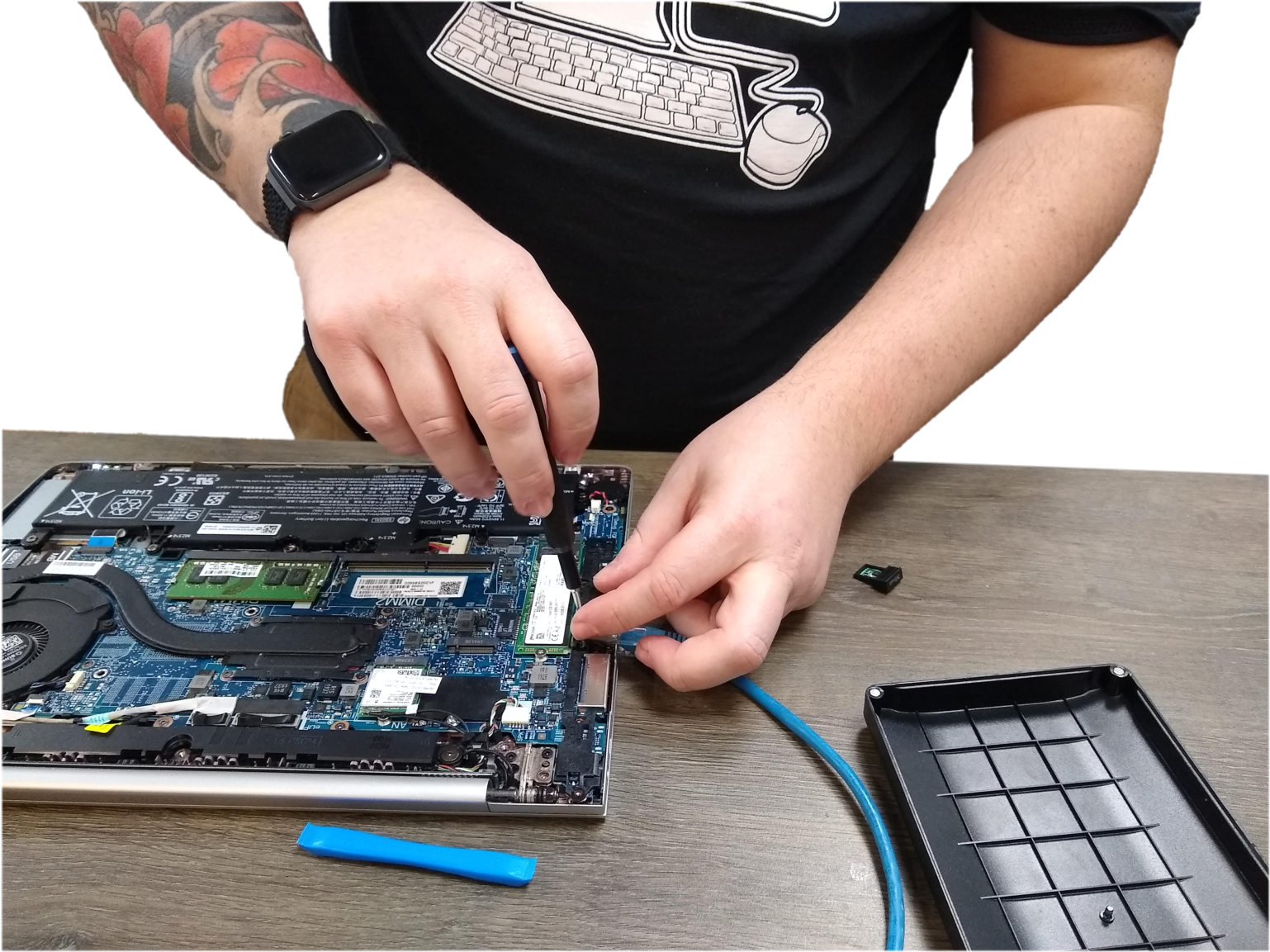 Man's hands mending a computer motherboard