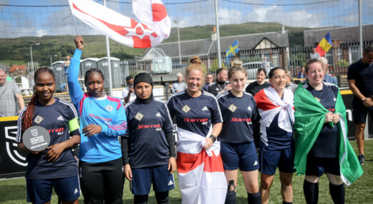 Group of five young women in football kit